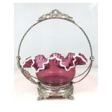 A ruby red brides basket with an ornate metal
