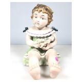 A 12 inch porcelain bisque piano, baby holding a