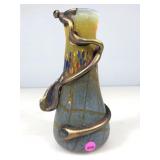 A handcrafted art, glass vase featuring hot,