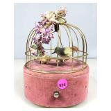 A vintage pink and gold birdcage music box