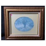 This is a framed oval print called Main Street by
