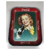 An original Coca-Cola serving tray showing pretty