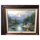 This framed wall art piece is Thomas Kincaidï¿½s