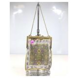A vintage micro beaded evening bag featuring an