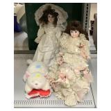 Porcelain dolls and stuff cat with red heart