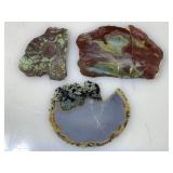 Three samples of thinly sliced geological stone
