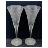 a pair of engraved champagne flutes Depicting,