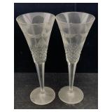 A pair of engraved champagne flutes with a