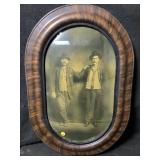 This is an antique oval wooden frame featuring