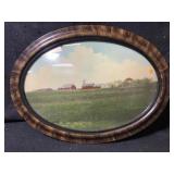 An antique oval picture frame featuring Tiger