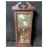 A vintage style wooden 31 day pendulum wall clock