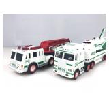 Two Hess company, larger toy trucks one is a hook
