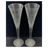 A pair of engraved champagne flutes featuring a