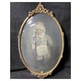 An antique Victorian style oval metal or brass