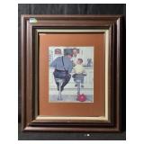 A framed vintage art print of Norman Rockwellï¿½s