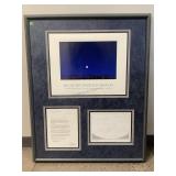 The framed item appears to be a commemorative