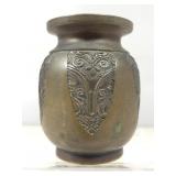 A small dark metal vessel, possibly a miniature