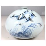 This is a squat, round white ceramic or porcelain