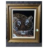 A framed vintage style tiger face painting on