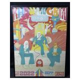 A framed concert poster for the American trio