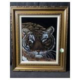 A framed vintage style tiger face painting on