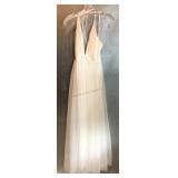 A white sleeveless maxi dress featuring a deep V
