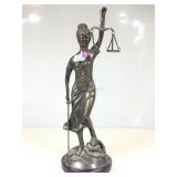 A metallic bronze tone figurine of lady justice,