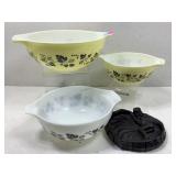 Three Pyrex nesting cooking bowls two are yellow,