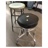 2 Stools, one on wheels and wood top says