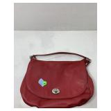 A red pebbled, leather Coach Turnlock hobo bag