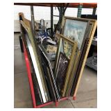 Cart of framed artwork from previous auctions,