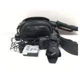 A black Samsung NX 20 mirrorless  digital camera