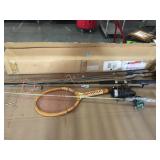 Lot of fishing poles, tennis racquet and