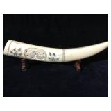 Scrimshaw horn on wood stands, 10 1/4 inches tall