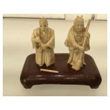 2 Ivory scrimshaw figurines mounted on wood