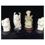 4 resin Asian figurines on wood stands, largest