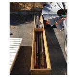 Long wooden box full of assorted pipes and