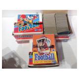 Opened boxes of football cards