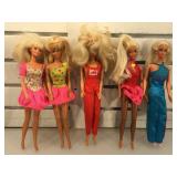 5 Barbie dolls,