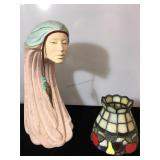 small leaded glass shade with a sculpture of a