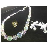 Clear beaded necklace and earrings matched with a