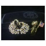 2 fashion pins. 1 pin is a gold-colored Angel