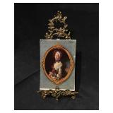 Fancy brass table easel and a colander of famous