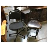 Pair of metal chairs one on wheels and both are