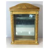Wooden display case with a glass front. There are