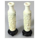 Set of carved ivory bud vases on Wooden stands.