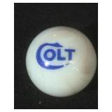 25 MM marble, white, displaying Colt