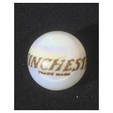 25 MM marble, white, displaying Winchester