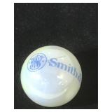 25 MM marble, white, displaying Smith & Wesson