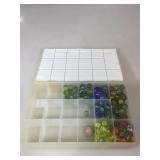 Partially filled tray of colorful marbles,